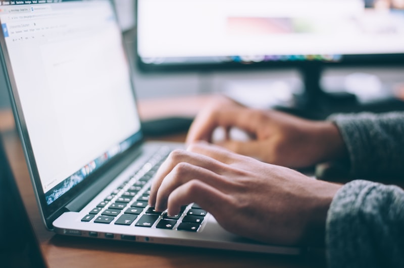 Typing keyword research on a laptop